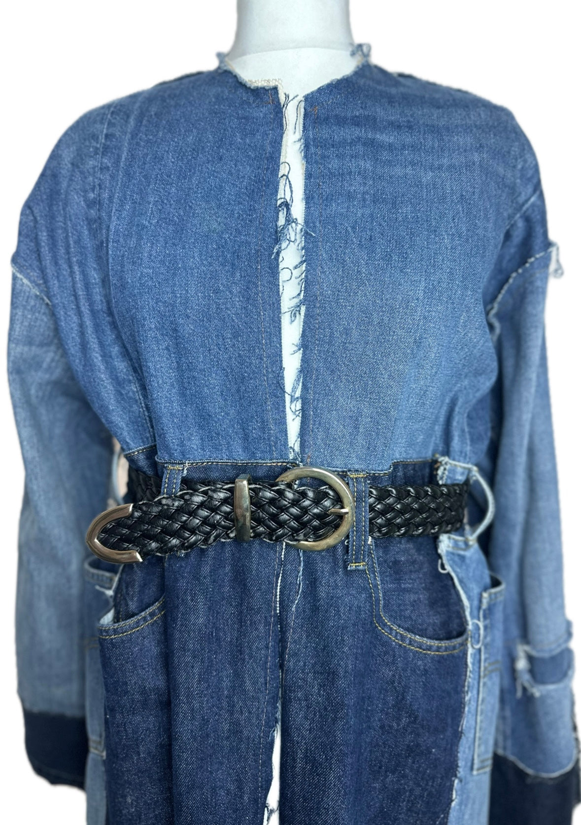 Long upcycled denim coat with frayed seams and macramé belt